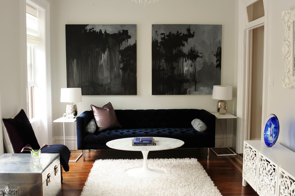 This is an example of a transitional living room in New York with white walls.