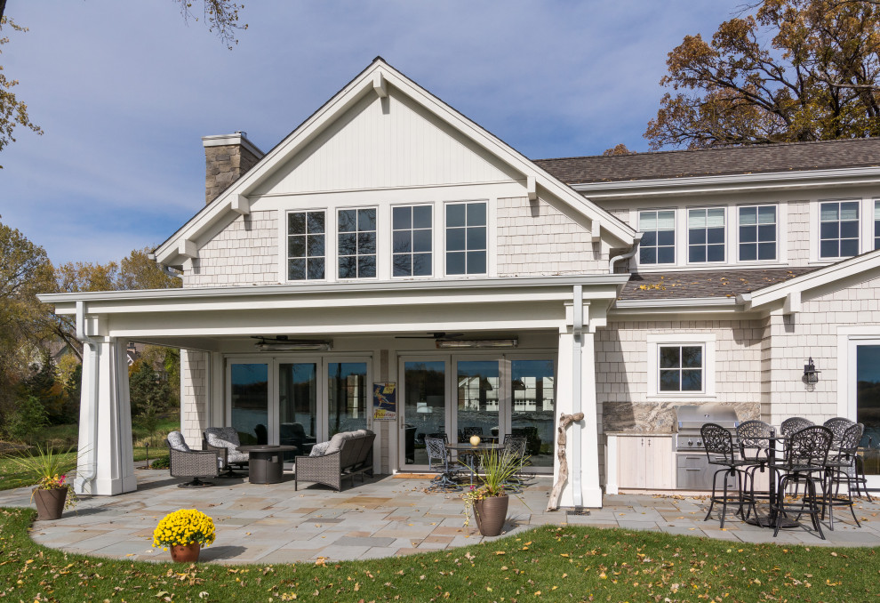 Beach style beige house exterior in Minneapolis with wood siding, a gable roof and a shingle roof.
