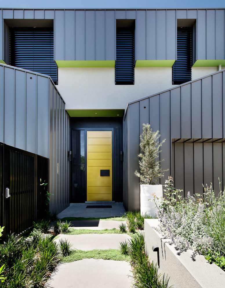 Large modern two-storey grey house exterior in Melbourne with mixed siding and a flat roof.