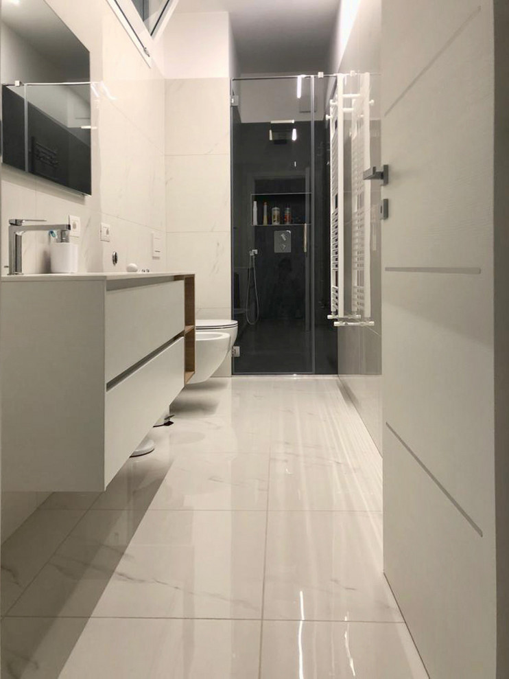Large modern powder room in Other with flat-panel cabinets, white cabinets, a two-piece toilet, black and white tile, porcelain tile, grey walls, porcelain floors, an integrated sink, solid surface benchtops, white floor and white benchtops.