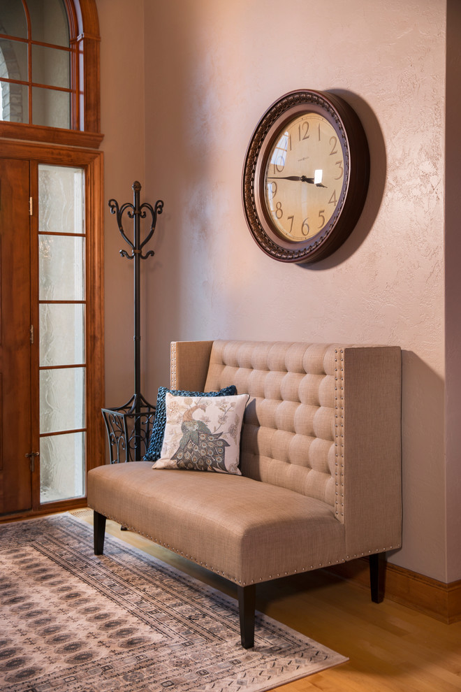 Inspiration for a mid-sized transitional front door in Milwaukee with beige walls and light hardwood floors.