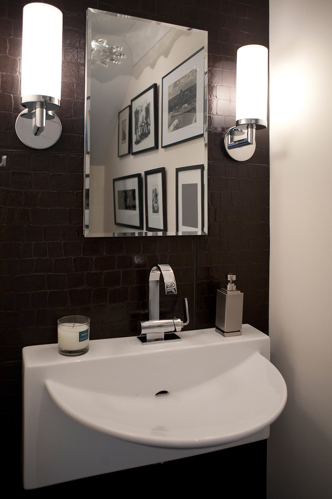 Small transitional brown tile and porcelain tile porcelain tile and brown floor bathroom photo with a two-piece toilet, white walls and a wall-mount sink