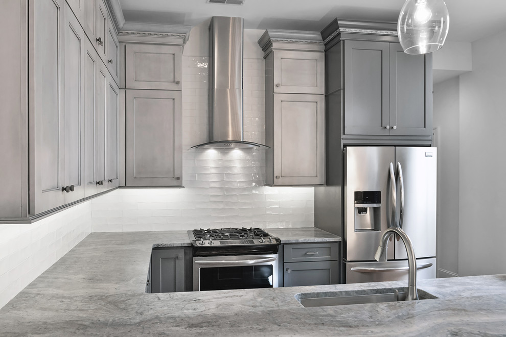 Design ideas for a small transitional kitchen in Charleston with shaker cabinets, grey cabinets, granite benchtops, white splashback, glass tile splashback, stainless steel appliances, dark hardwood floors, a peninsula and brown floor.