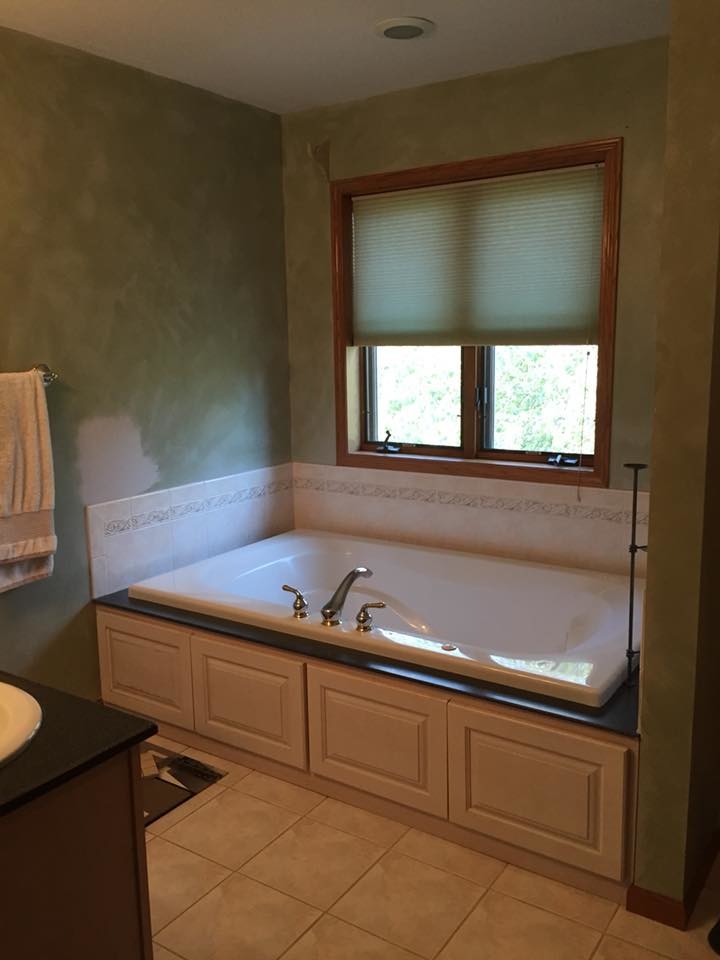 Example of a transitional master multicolored tile and mosaic tile porcelain tile and brown floor freestanding bathtub design with shaker cabinets, white cabinets, a vessel sink, quartz countertops, a hinged shower door and multicolored countertops