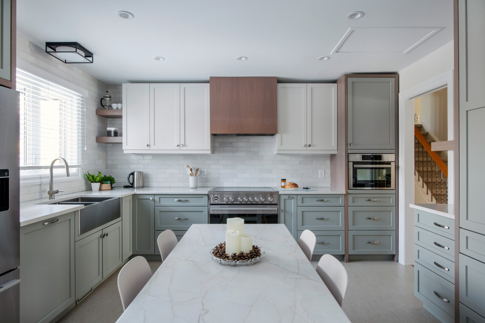 Eat-in kitchen - mid-sized transitional u-shaped linoleum floor and gray floor eat-in kitchen idea in Ottawa with a farmhouse sink, shaker cabinets, gray cabinets, quartz countertops, white backsplash, subway tile backsplash, stainless steel appliances, an island and white countertops