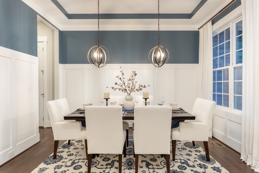 Transitional separate dining room in Raleigh with blue walls, medium hardwood floors and brown floor.