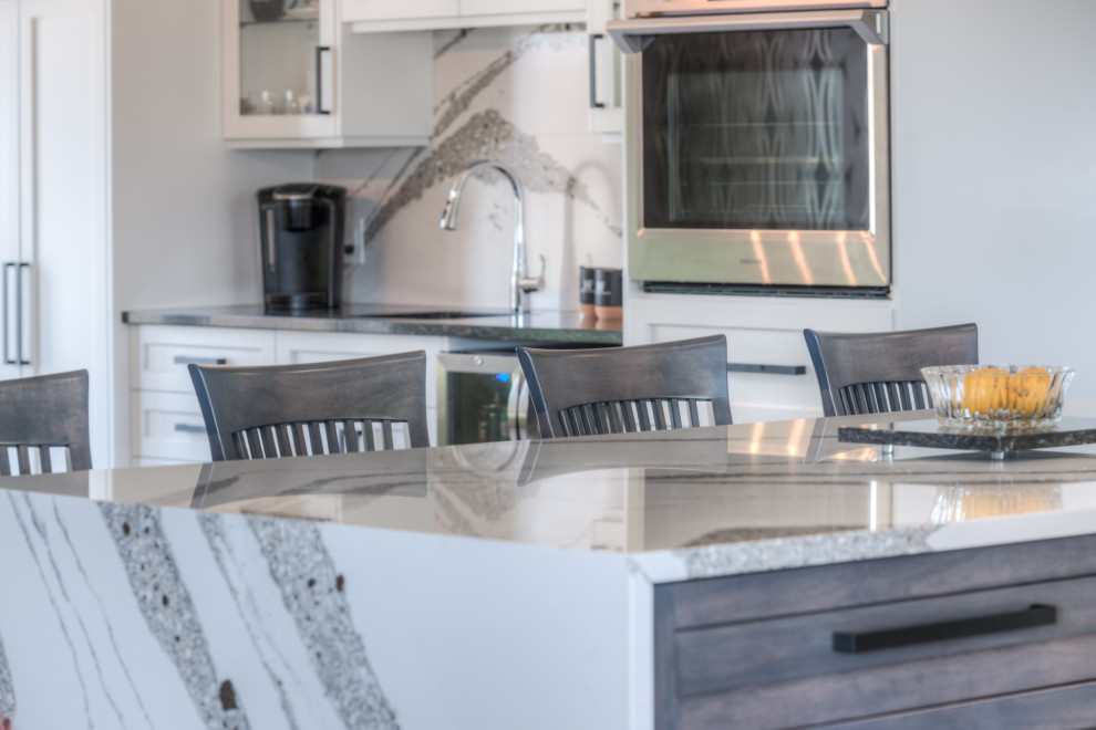 Eat-in kitchen - transitional eat-in kitchen idea with shaker cabinets, white cabinets, stainless steel appliances and an island
