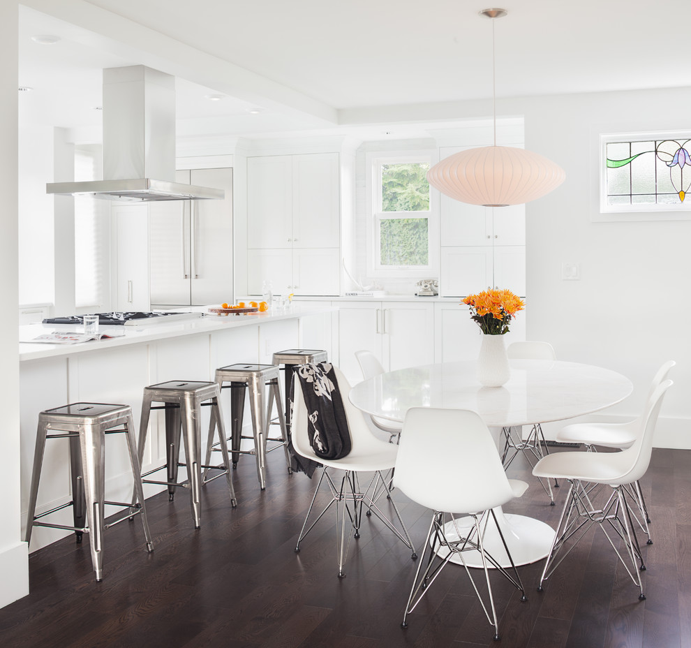 Inspiration for a transitional kitchen/dining combo in Vancouver with white walls and dark hardwood floors.