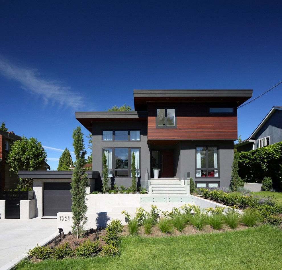 Mid-sized contemporary three-storey exterior in Vancouver with a flat roof.