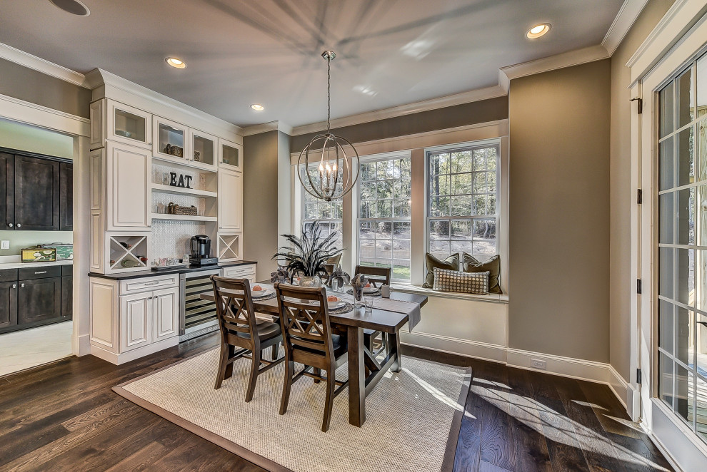 Inspiration for a large transitional dining room in Charlotte with beige walls and medium hardwood floors.