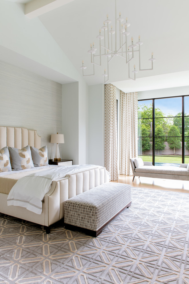 Large mediterranean master bedroom in Dallas with light hardwood floors and grey walls.