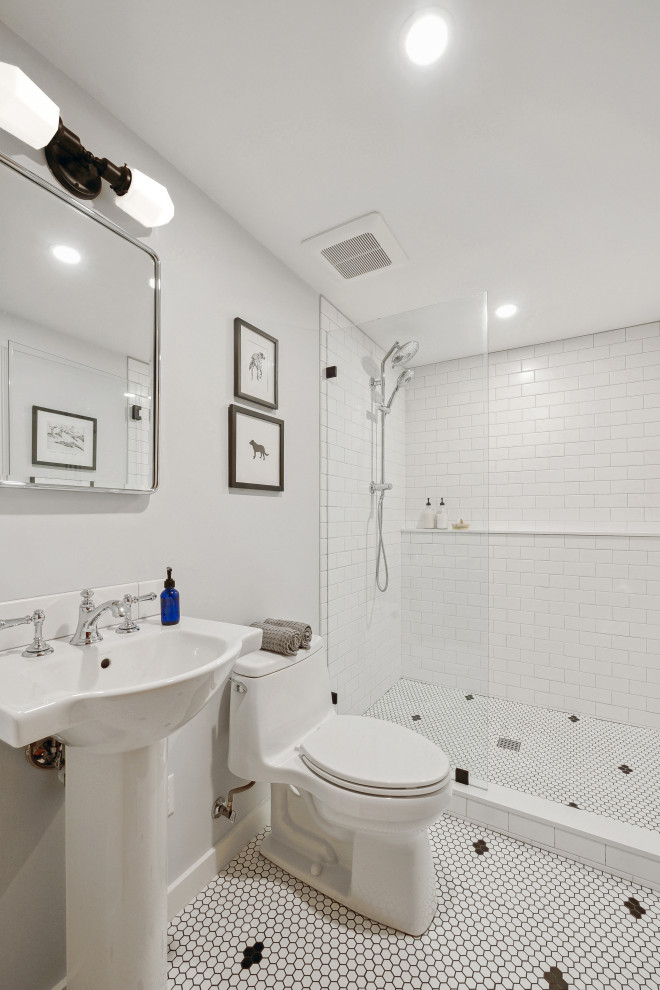 This is an example of a small traditional family bathroom in Portland with an alcove shower, a one-piece toilet, white tiles, metro tiles, grey walls, mosaic tile flooring, a pedestal sink, white floors, a hinged door, a wall niche, a single sink and a freestanding vanity unit.
