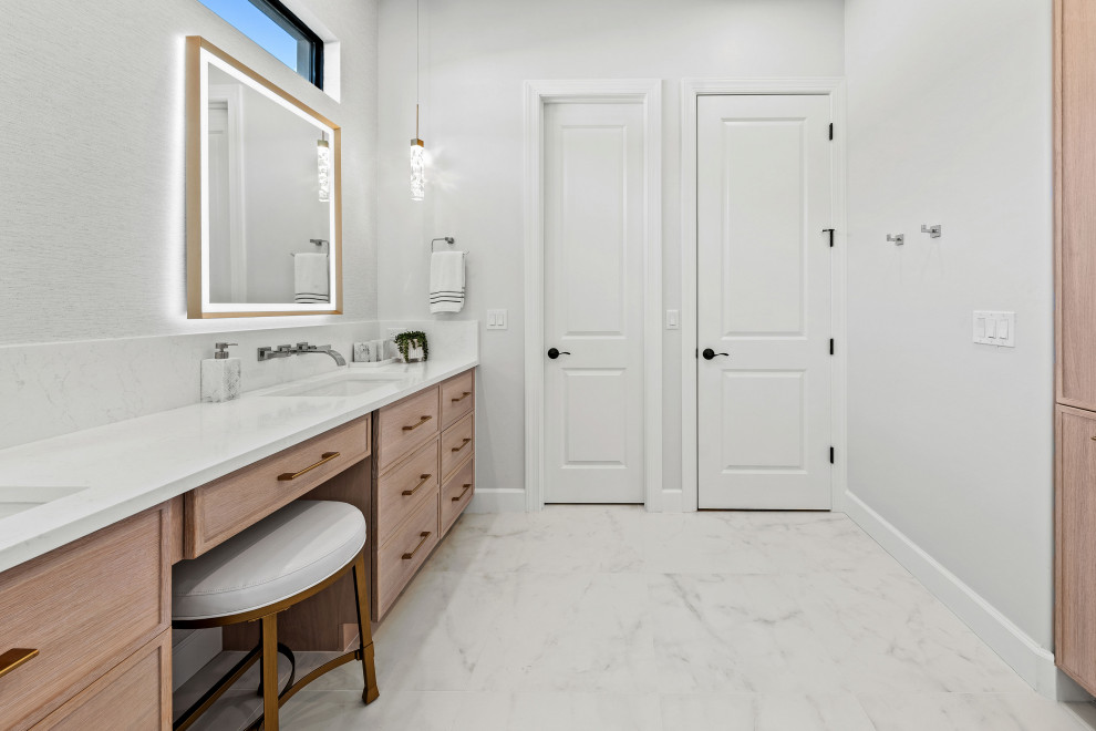 Inspiration for a transitional master gray tile and porcelain tile porcelain tile, white floor and double-sink walk-in shower remodel with shaker cabinets, light wood cabinets, a two-piece toilet, white walls, an undermount sink, quartz countertops, white countertops, a niche and a built-in vanity