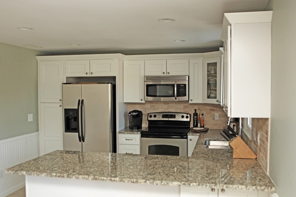 Photo of a mid-sized modern u-shaped eat-in kitchen in Providence with a double-bowl sink, shaker cabinets, white cabinets, granite benchtops, beige splashback, terra-cotta splashback, stainless steel appliances and ceramic floors.