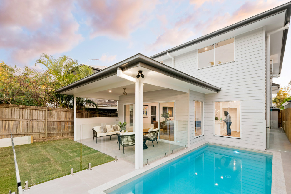 Photo of a medium sized and white classic two floor detached house in Brisbane with concrete fibreboard cladding, a pitched roof, a metal roof, a black roof and shiplap cladding.