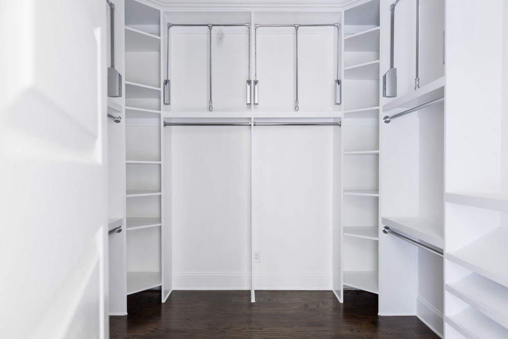 Inspiration for a large transitional gender-neutral storage and wardrobe in Atlanta with white cabinets, dark hardwood floors and brown floor.