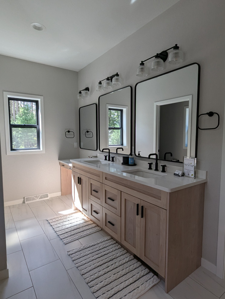 Large transitional l-shaped vinyl floor and brown floor eat-in kitchen photo with a double-bowl sink, shaker cabinets, light wood cabinets, quartzite countertops, white backsplash, ceramic backsplash, stainless steel appliances, an island and white countertops