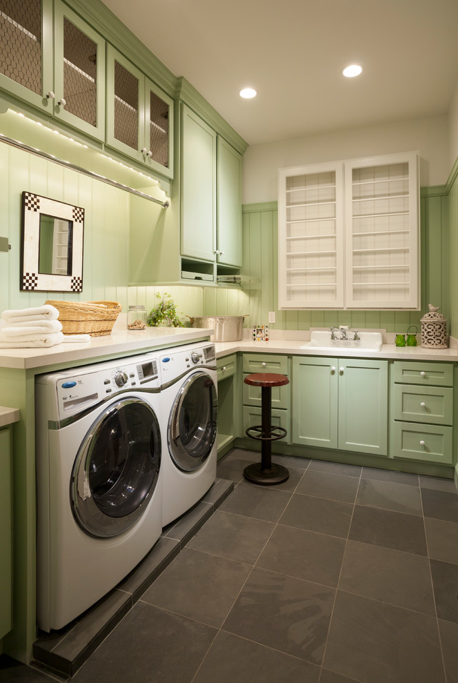 Large traditional l-shaped dedicated laundry room in Salt Lake City with green cabinets, grey floor, a drop-in sink, shaker cabinets, quartz benchtops, white walls, concrete floors and a side-by-side washer and dryer.