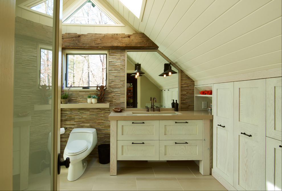 This is an example of a mid-sized master bathroom in Other with recessed-panel cabinets, beige cabinets, a corner shower, a one-piece toilet, multi-coloured tile, ceramic tile, white walls, ceramic floors, an undermount sink, engineered quartz benchtops, beige floor, a hinged shower door, brown benchtops, a single vanity, a built-in vanity, vaulted and planked wall panelling.