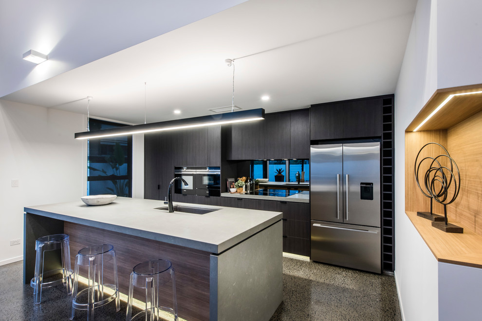 Photo of a contemporary galley kitchen in Brisbane with an undermount sink, flat-panel cabinets, black cabinets, mirror splashback, with island, grey floor and grey benchtop.