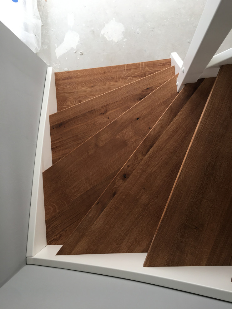 Inspiration for a contemporary wood curved staircase in Frankfurt with wood railing.