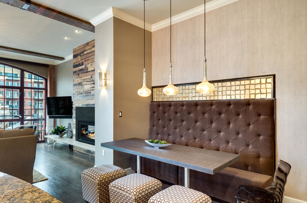This is an example of a contemporary open plan dining in Denver with beige walls and dark hardwood floors.
