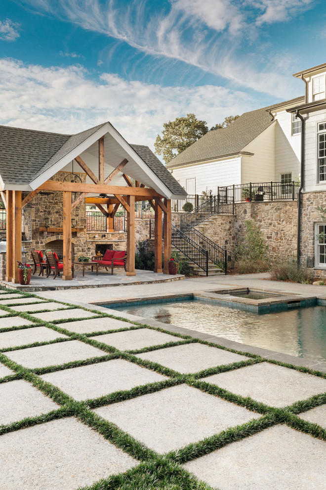Mid-sized elegant backyard rectangular natural pool house photo in Other