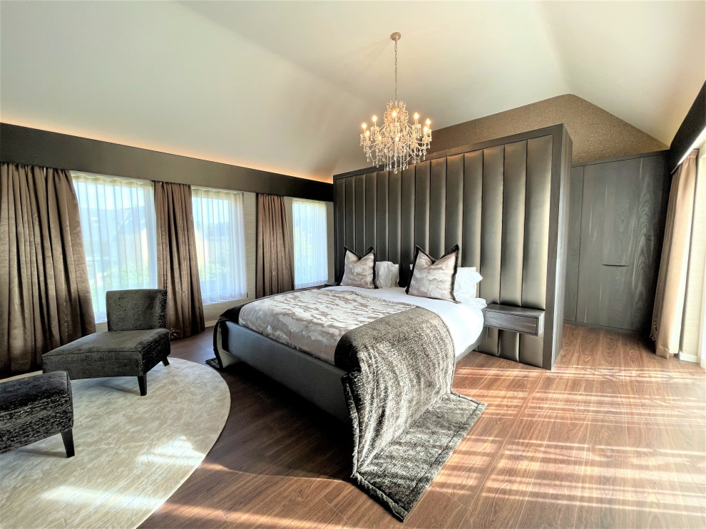 Design ideas for an expansive contemporary master bedroom in Other with vinyl floors, vaulted and wallpaper.