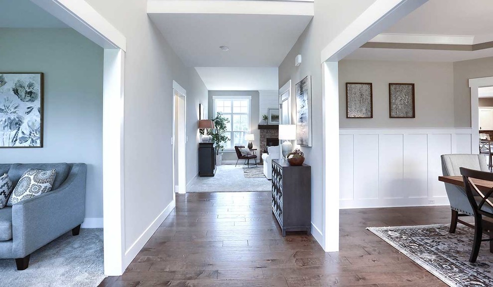 Large country foyer in Other with grey walls, medium hardwood floors, a single front door and a white front door.