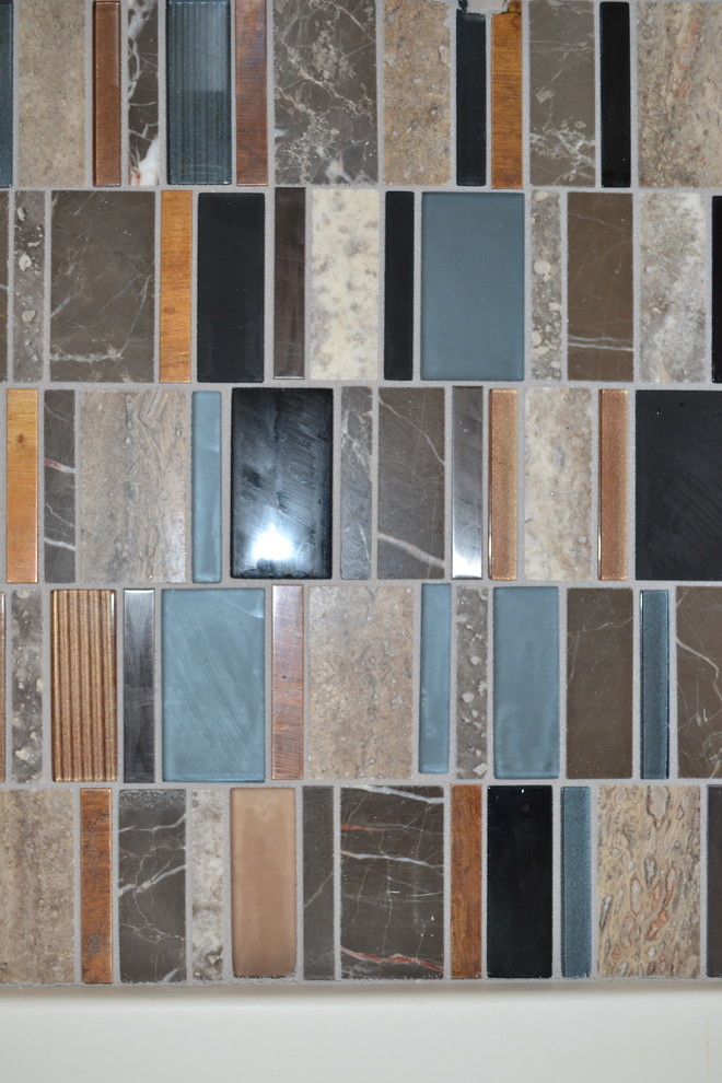 Example of a mid-sized transitional kitchen design with an integrated sink, raised-panel cabinets, multicolored backsplash and glass tile backsplash