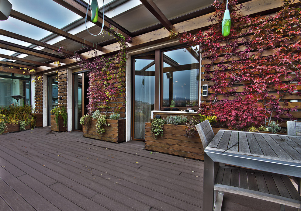Photo of a large contemporary rooftop deck in Turin with a pergola and a container garden.