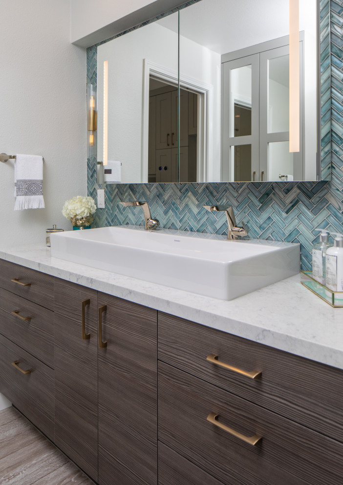 Photo of a large master wet room bathroom in San Diego with flat-panel cabinets, dark wood cabinets, a one-piece toilet, blue tile, white walls, a vessel sink, engineered quartz benchtops, green floor, a hinged shower door and white benchtops.