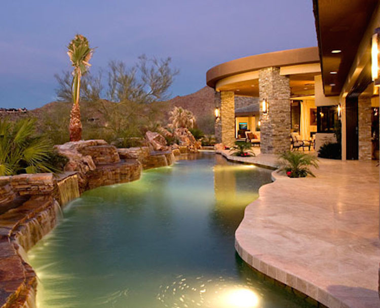 Large transitional backyard stone and custom-shaped lap pool fountain photo
