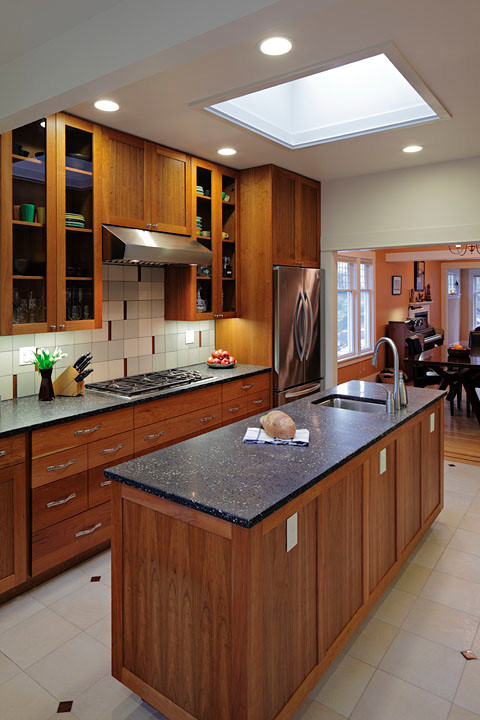 Large transitional eat-in kitchen photo in Seattle with a drop-in sink, flat-panel cabinets, medium tone wood cabinets, multicolored backsplash, stainless steel appliances and an island