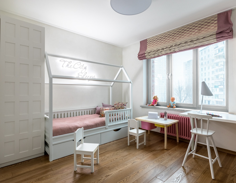 Design ideas for a mid-sized contemporary gender-neutral kids' bedroom for kids 4-10 years old in Moscow with white walls, medium hardwood floors and brown floor.