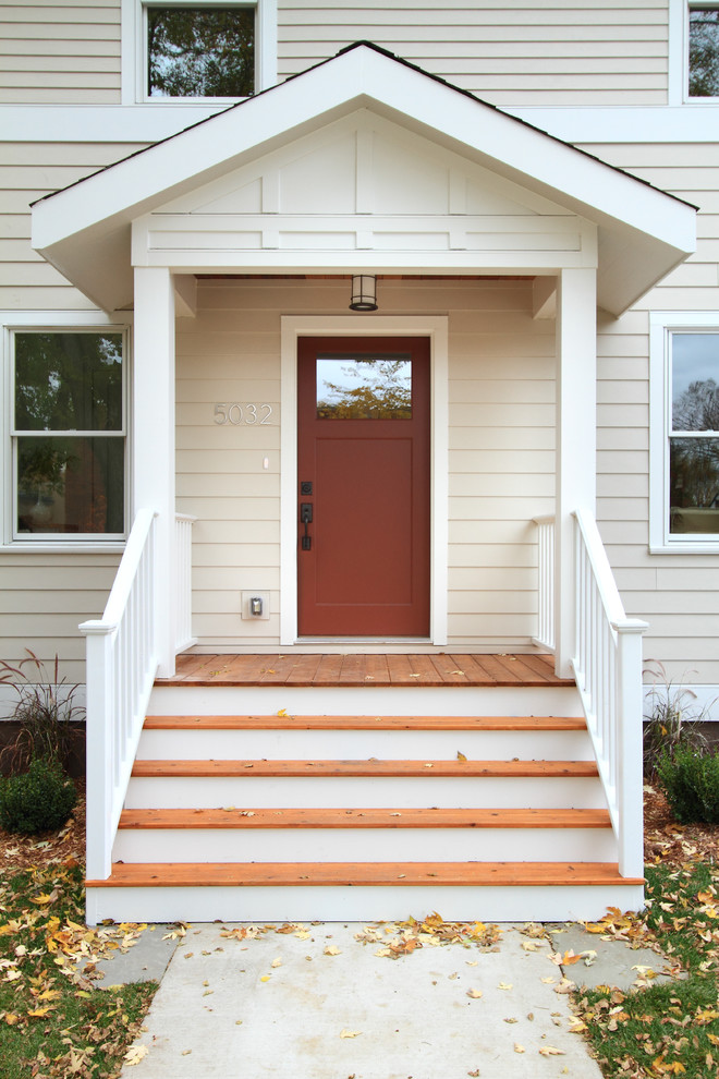 This is an example of a traditional entryway in Minneapolis with a red front door.