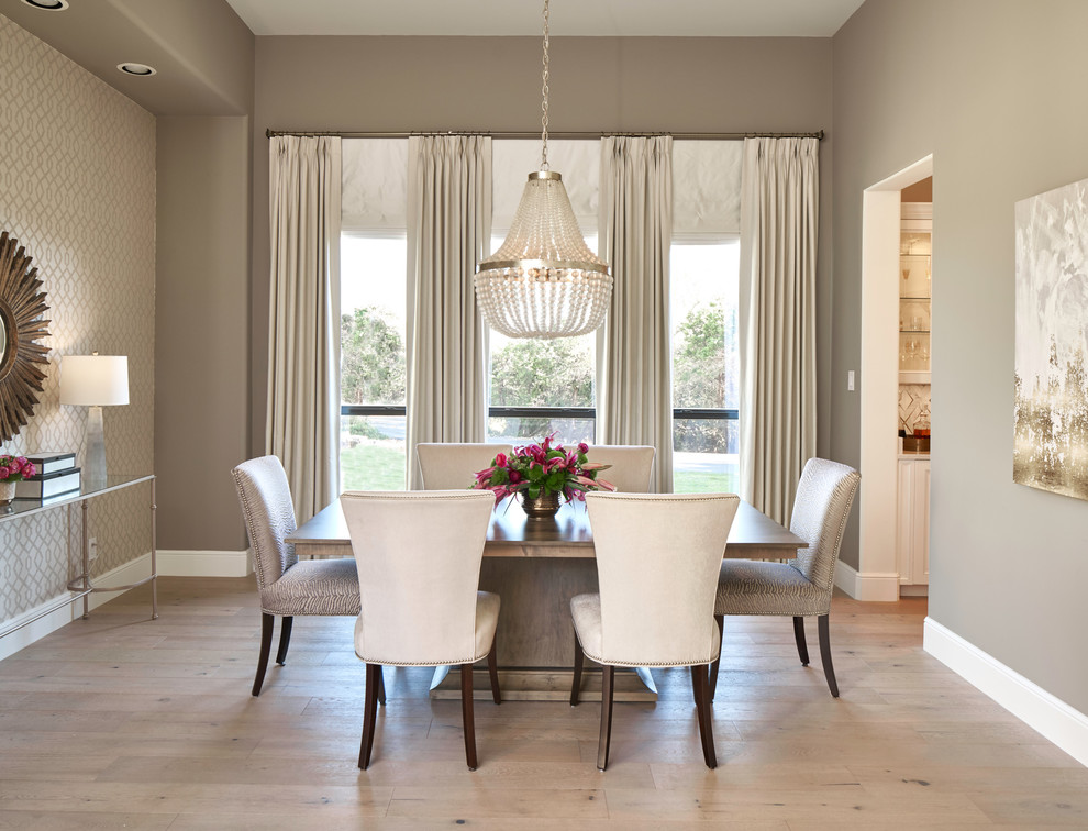 Inspiration for a transitional separate dining room in Austin with brown walls, light hardwood floors and beige floor.