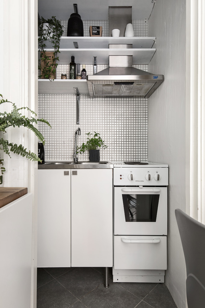 Design ideas for a small scandinavian single-wall separate kitchen in Stockholm with a drop-in sink, flat-panel cabinets, white cabinets and white splashback.