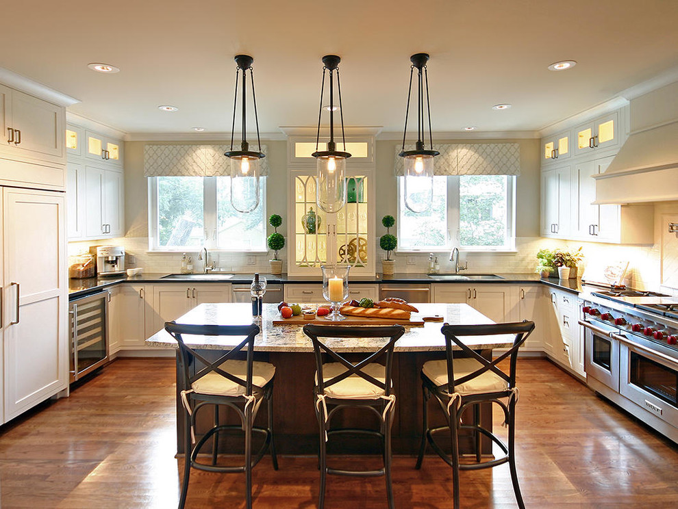 Inspiration for a large transitional medium tone wood floor kitchen remodel in Houston with an undermount sink, recessed-panel cabinets and an island