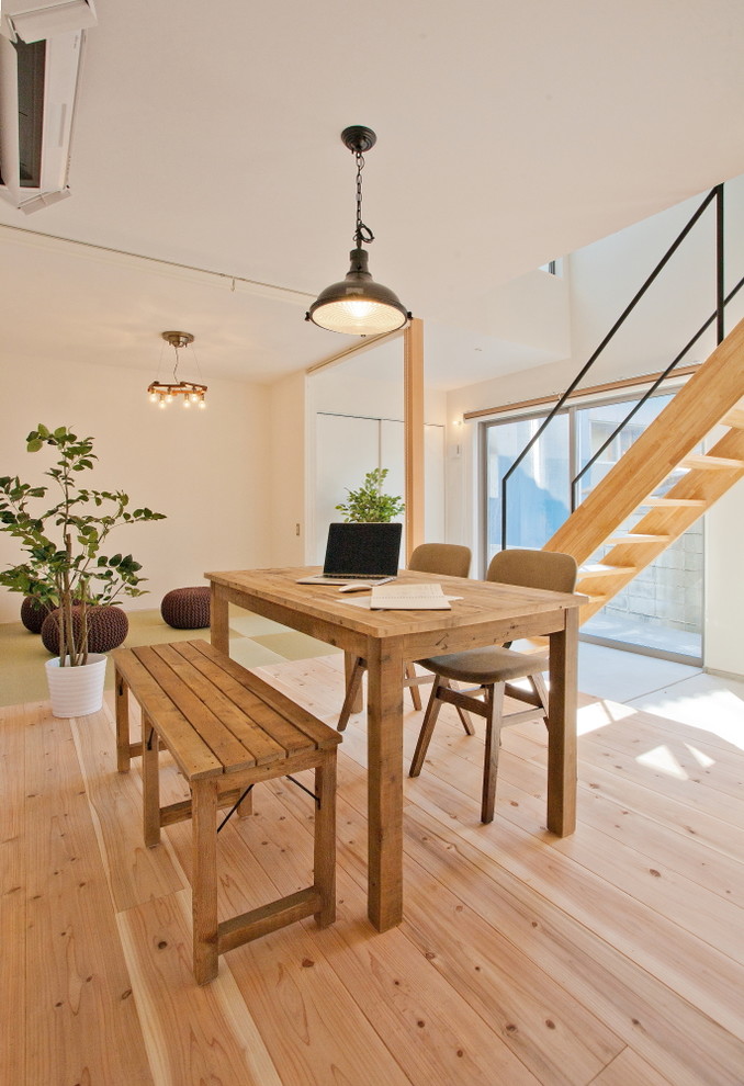 Photo of a contemporary dining room in Tokyo Suburbs with white walls and light hardwood floors.