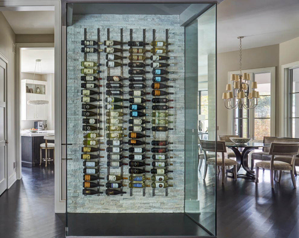 Mid-sized contemporary wine cellar in Chicago with dark hardwood floors, display racks and brown floor.