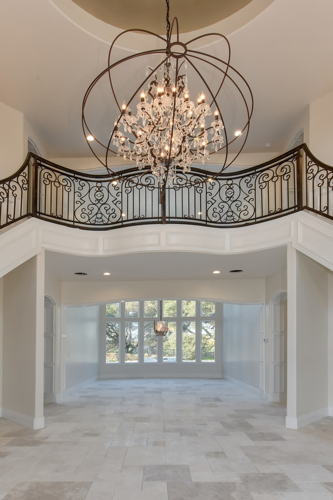 Large transitional carpeted curved staircase in Sacramento with carpet risers and metal railing.