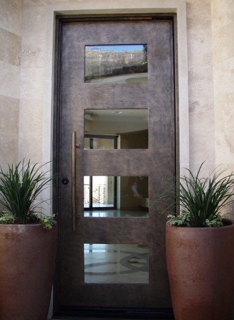 Inspiration for a small contemporary front door in Austin with beige walls, marble floors, a single front door and a brown front door.