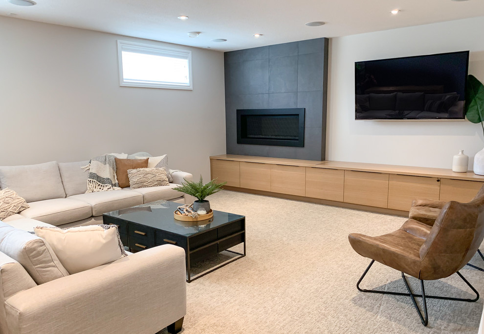 This is an example of a mid-sized transitional fully buried basement in Other with white walls, carpet, a standard fireplace, a tile fireplace surround and beige floor.