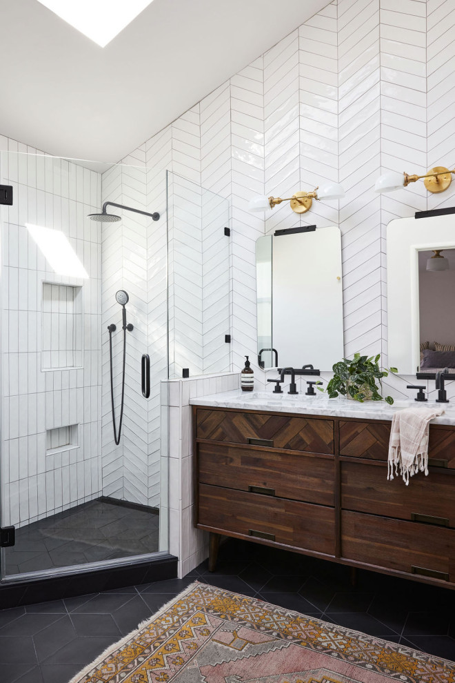 Photo of a mid-sized midcentury master bathroom in San Francisco with brown cabinets, a corner shower, white tile, ceramic tile, porcelain floors, a drop-in sink, marble benchtops, black floor, a hinged shower door, a double vanity, a freestanding vanity and vaulted.