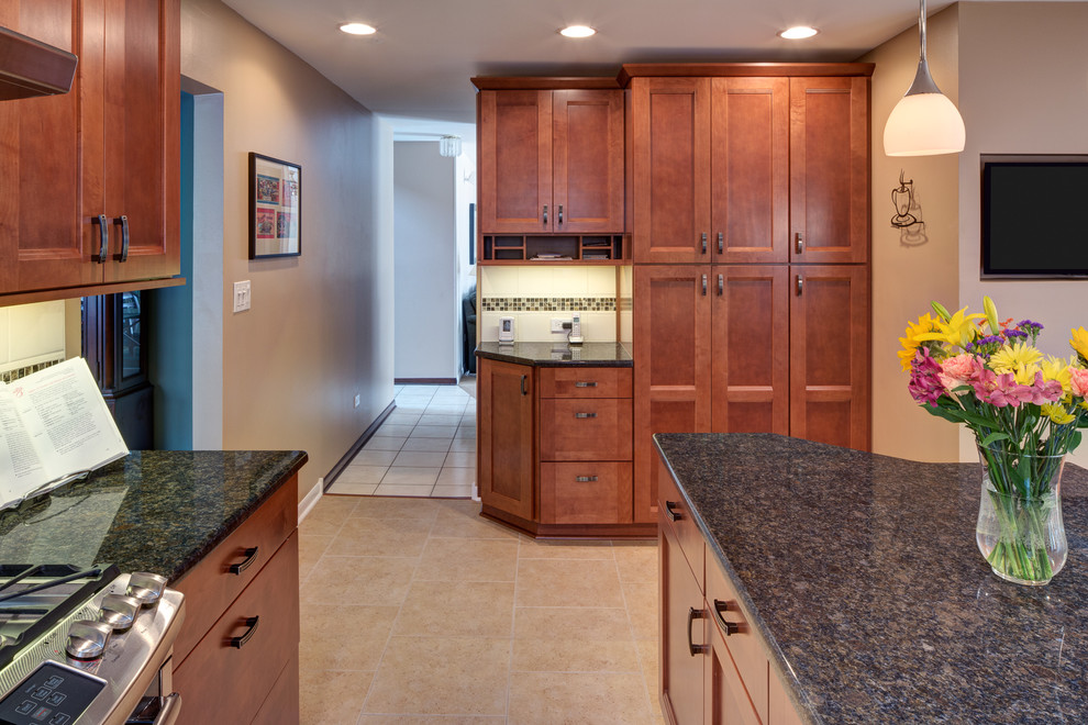 Inspiration for a mid-sized transitional l-shaped porcelain tile kitchen remodel in Chicago with recessed-panel cabinets, medium tone wood cabinets, quartz countertops, white backsplash, mosaic tile backsplash and stainless steel appliances