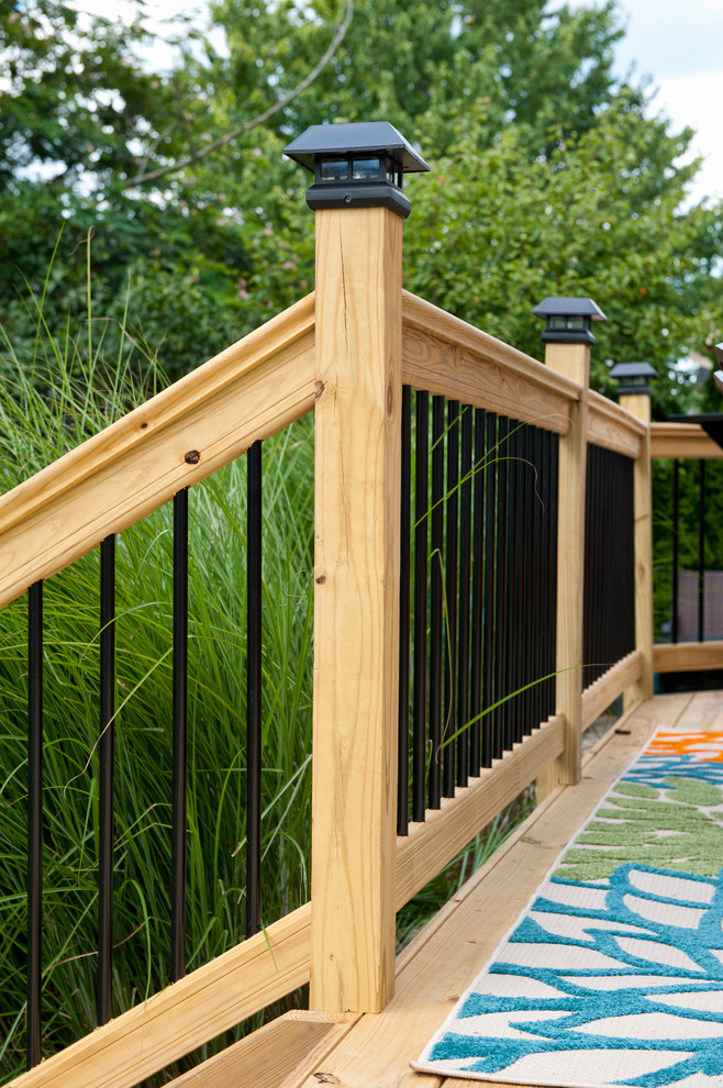 Example of a mid-sized minimalist backyard deck design in Columbus with no cover