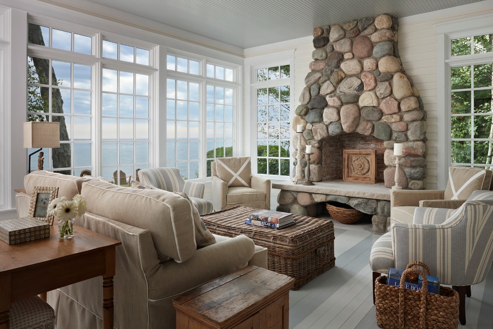 Design ideas for a mid-sized beach style enclosed living room in Other with white walls, painted wood floors, a standard fireplace and a stone fireplace surround.