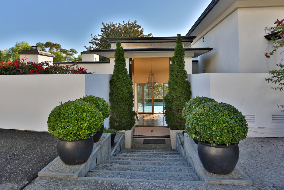 This is an example of a transitional entryway in Santa Barbara with a double front door.