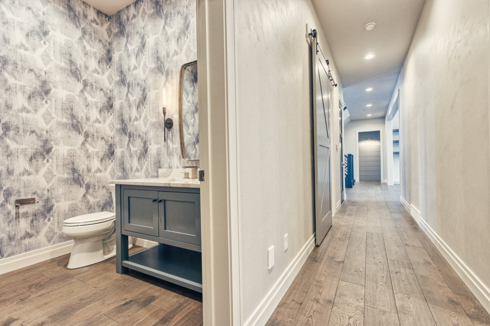 Example of a huge transitional medium tone wood floor and brown floor hallway design with gray walls